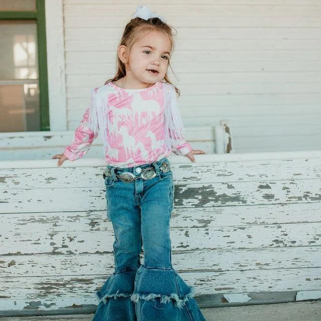 Girl wearing oval concho belt with blue denim jeans