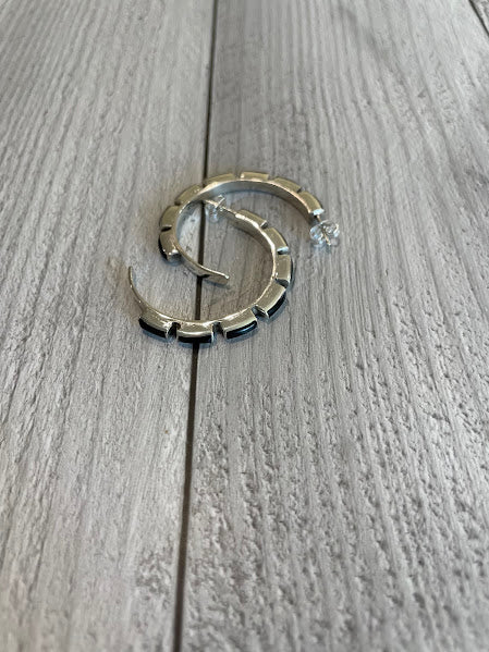 Half hoop sterling silver and black onyx post earrings, 1.5 inch, flat lay view