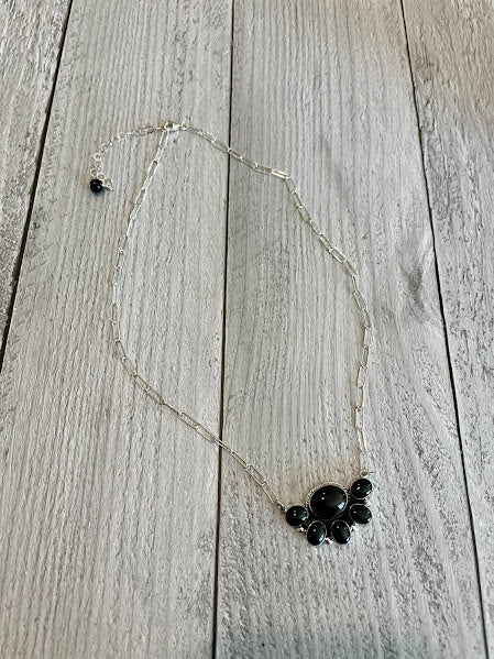 Sterling silver black onyx cluster necklace with paperclip chain, laid flat